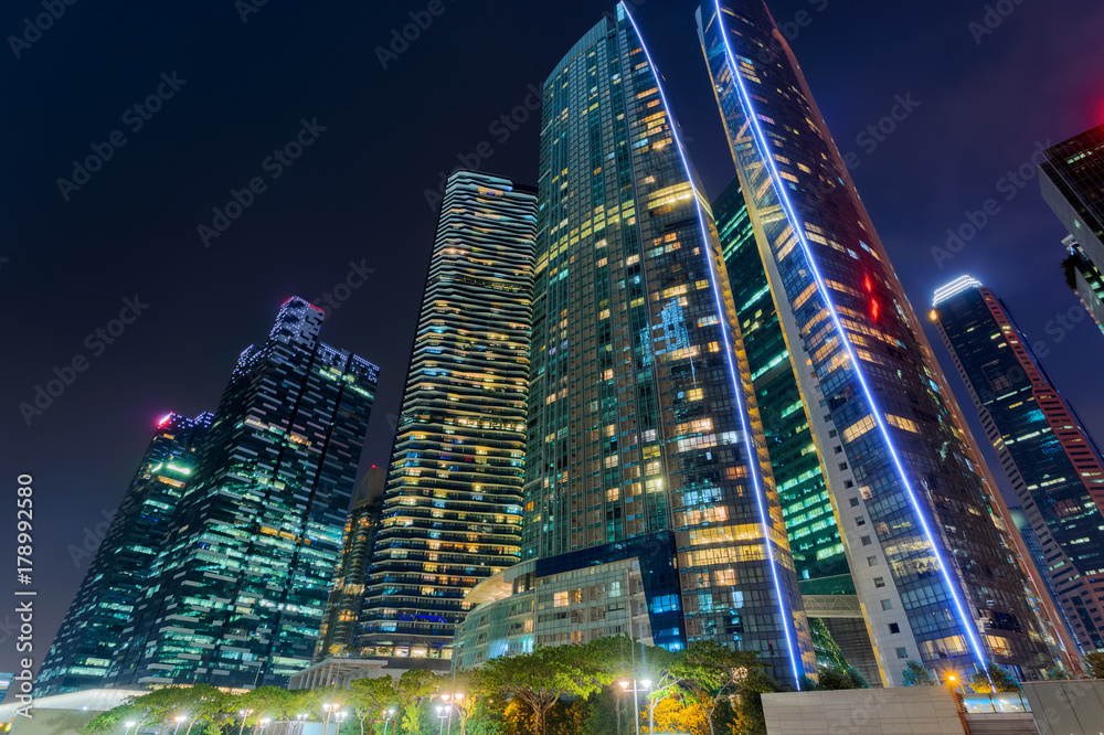 Bottom view to skyscrapers at downtown district. Singapore at night - obrazy, fototapety, plakaty 
