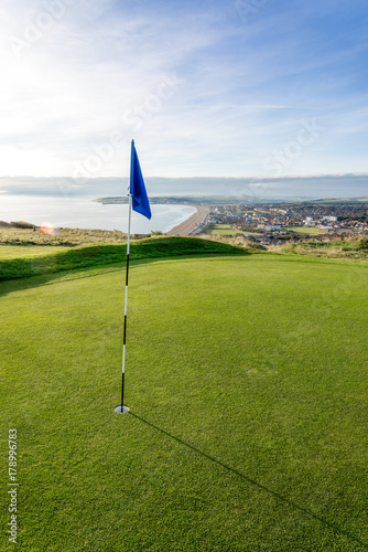 Golf course above beach with seaside view