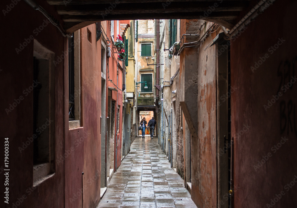 People in the end of a narrow venetian street, Venice