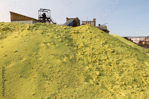 Heaps of sulphur - raw material for pulp and paper mill. Selective focus.