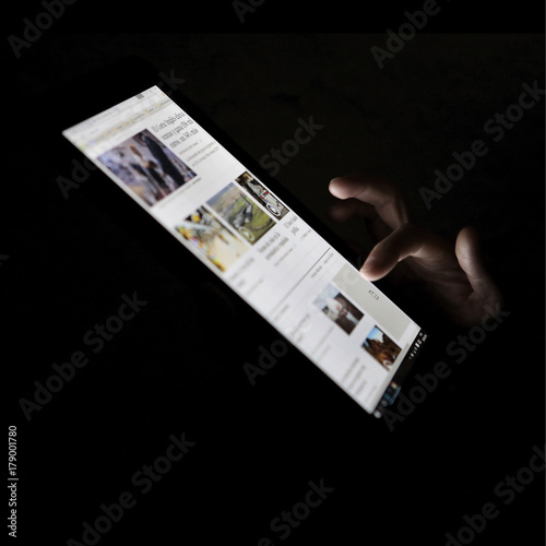 woman checking news at her pad
