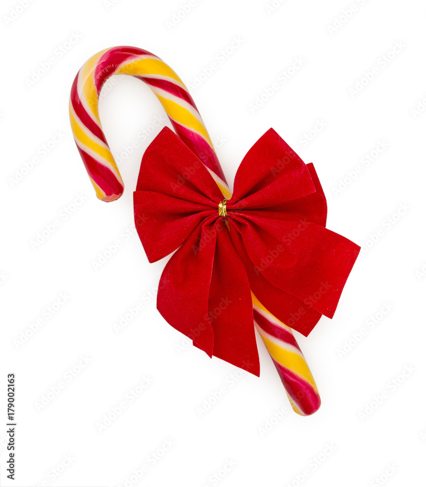 Christmas candy cane with red bow isolated on white background, top view.