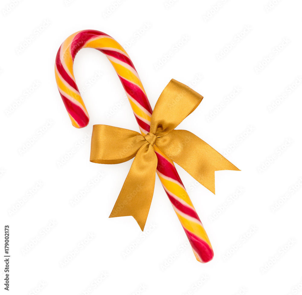 Christmas candy cane with gold bow isolated on white background, top view.