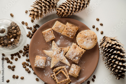 Christmas cookies, Christmas spices and cones on white background photo
