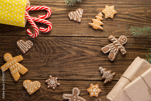 Chrismas cookies, candy canes on wooden background. Holiday mood. Top view.