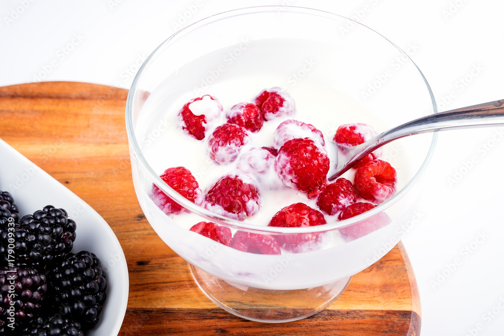 Healthy Greek yogurt bowl with fresh berry, on a white background Healthy Greek yogurt bowl with fresh berry, on a white background