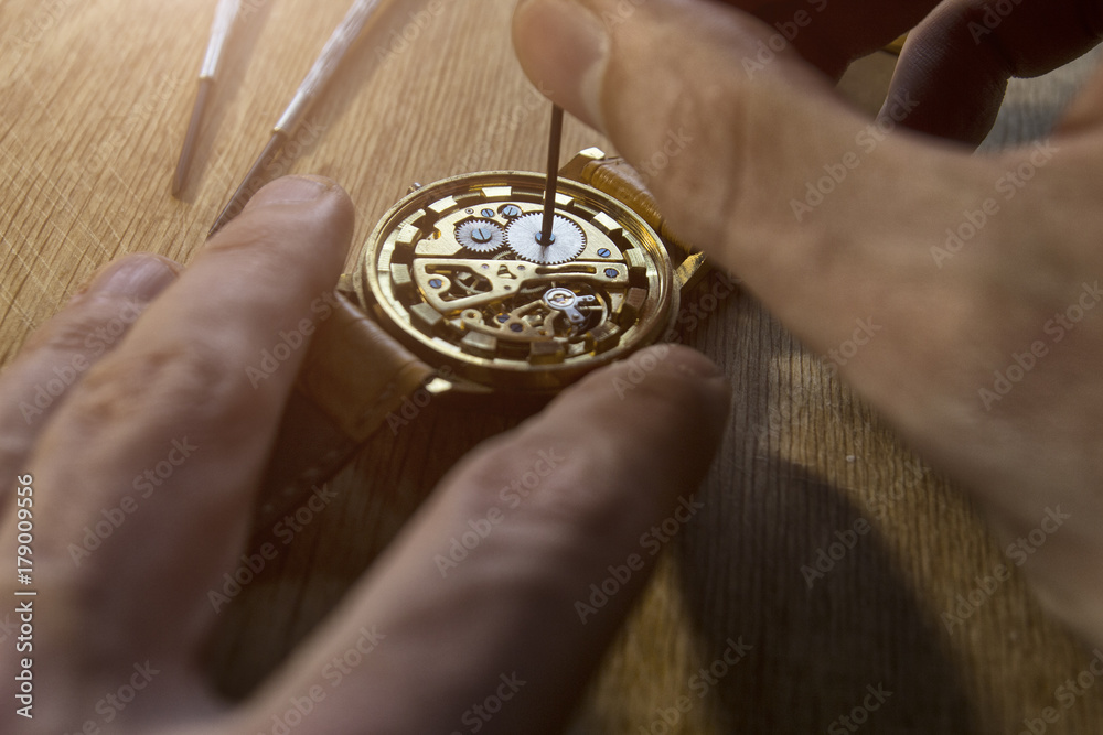 Watchmaker is repairing the mechanical watches in his workshop