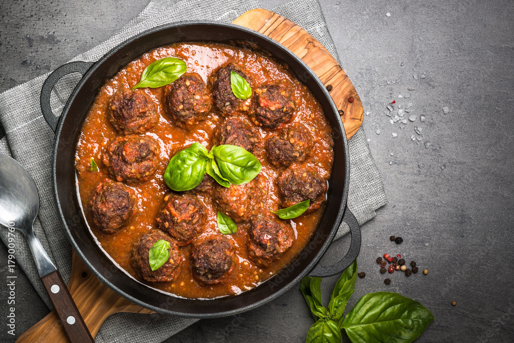 Meatballs in tomato sauce on a black background. Meatballs in tomato sauce on a black background.