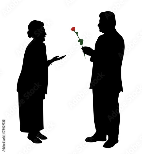 Senior man giving red rose to woman or wife