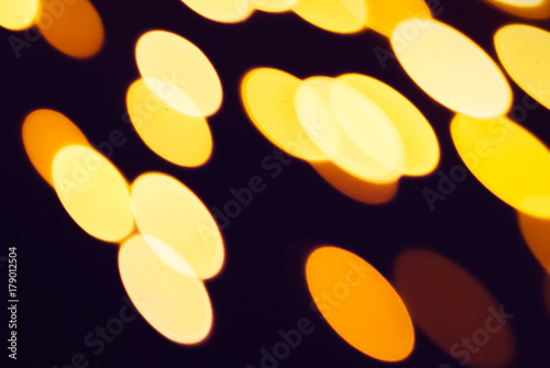 Abstract xmas Gold sparkles or glitter lights. Christmas festive gold background. Defocused bokeh  particles. Template for design