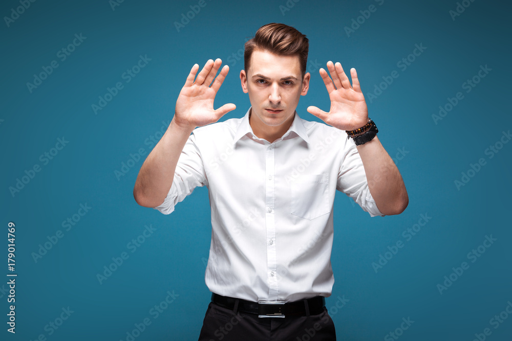 Fototapeta premium Young handsome businessman in costly watch and white shirt