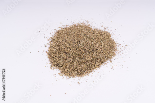 Oregano desiccated leaves on a white table background 