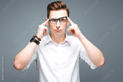 Attractive mature businessman in costly watch, black glasses and white shirt