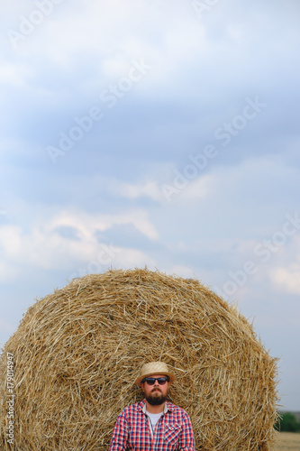 man resting after hay in haystacks photo