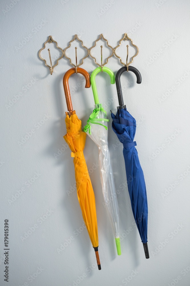 Fotografie Colorful umbrellas hanging on hook