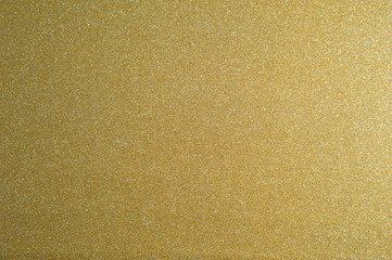 Texture of golden glitter paper background for design Christmas or New Year's cards