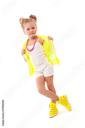 Pretty little girl in yellow shirt, white shorts and yellow boots