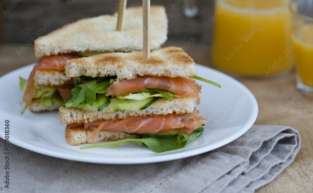 Fresh and tasty sandwich with ham, salmon and vegetables Fresh and tasty sandwich with ham, salmon and vegetables
