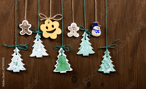 hanging christmas cookies on a wooden background