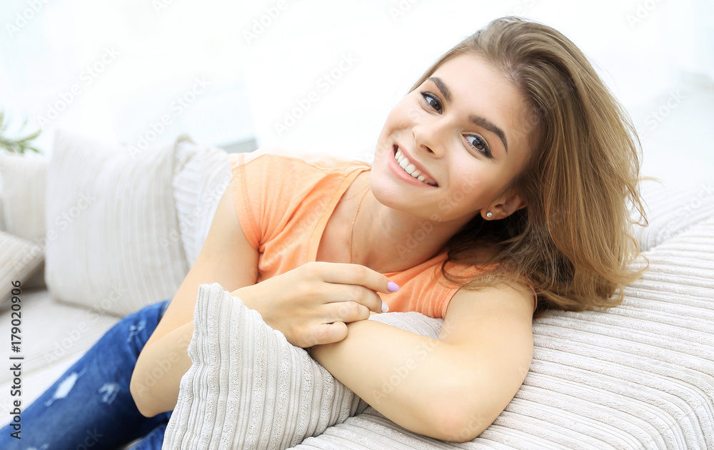 young female student relaxing at home on the couch.