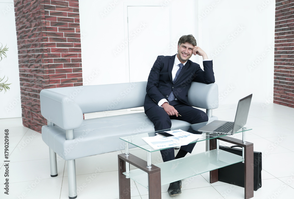 Successful businessman in modern spacious office