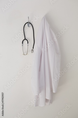 Canvas Print Laboratory coat and stethoscope hanging on hook