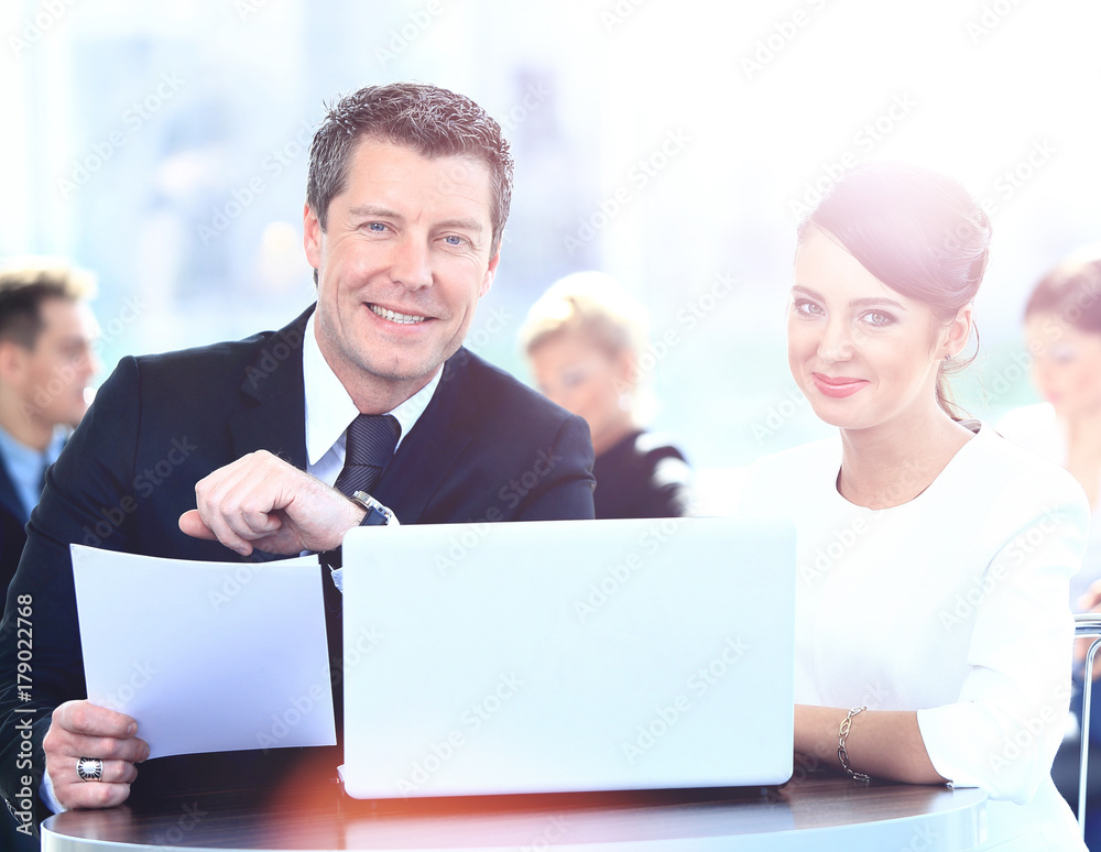 Businessmen and businesswoman discussing tasks sitting at office table Businessmen and businesswoman discussing tasks sitting at office table