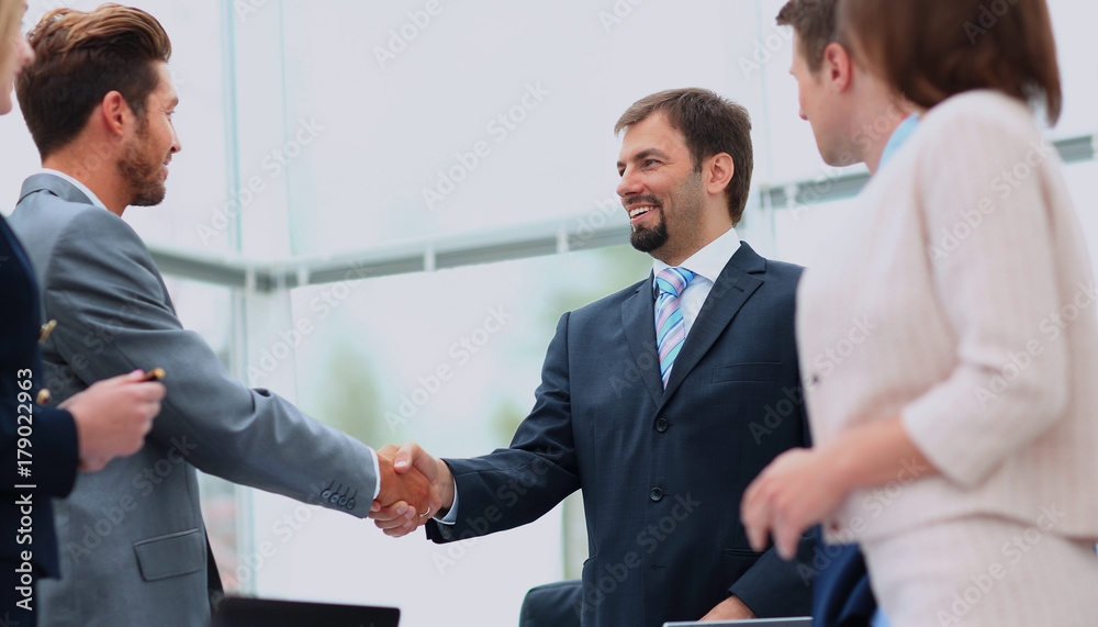 Business colleagues sitting at a table during a meeting with two Business colleagues sitting at a table during a meeting with two