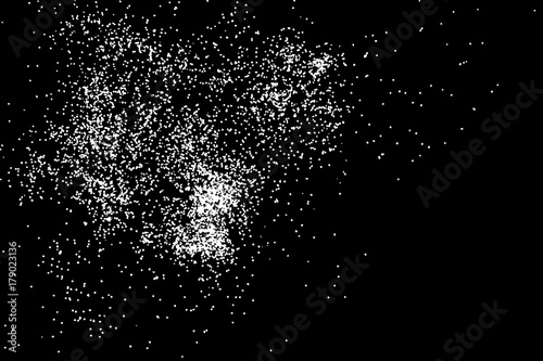 Abstract grainy texture isolated on black background. Top view. Dust, sand blow or bread crumbs. Silhouette of food flakes such as salt or almond or wheat flour spread on the flat surface or table.