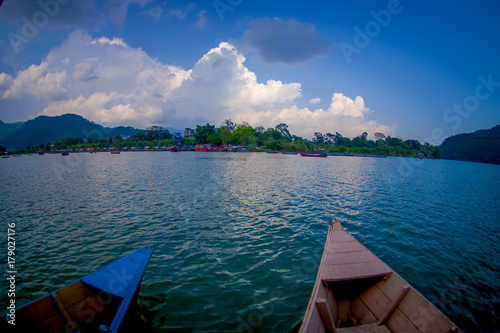 Close up of the tip of the boat with a beautiful landscape of the Phewa tal-lake with buildings in the horizont in Pokhara city Kaski district Gandaki zone-Nepal photo