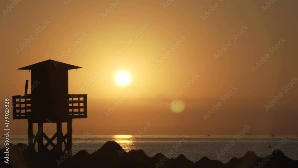 Silhouette of a lifeguard tower on the beach Silhouette of a lifeguard tower on the beach