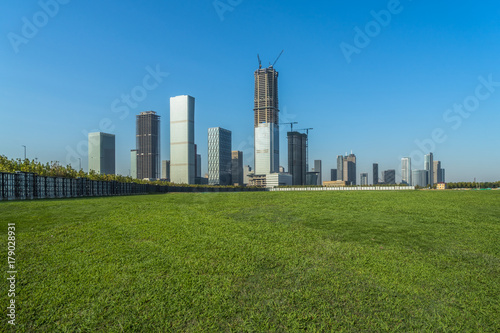 green lawn with city skyline background, tianjin, china