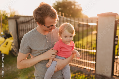 Father and baby daughter outside in the sunset