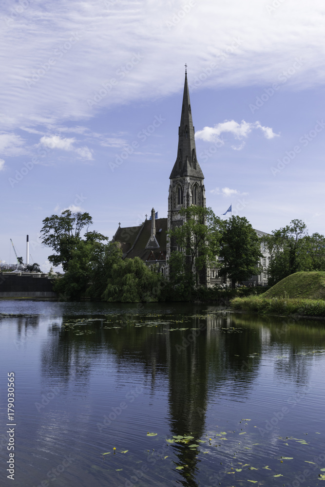St Alban's Church in Copenhagen Denmark viewed across the water with reflection