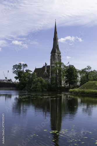 St Alban's Church in Copenhagen Denmark viewed across the water with reflection