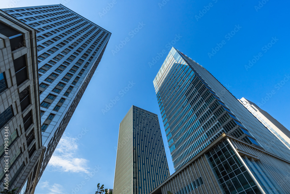 low angle view of skyscrapers in city of China against blue sky