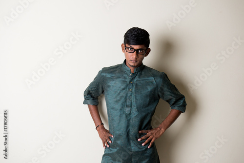 teenage indian male in traditional dress looking angry and frustrated