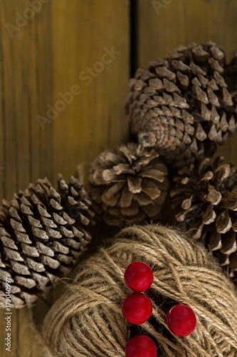Directly above shot of pine cones with thread spool with push
