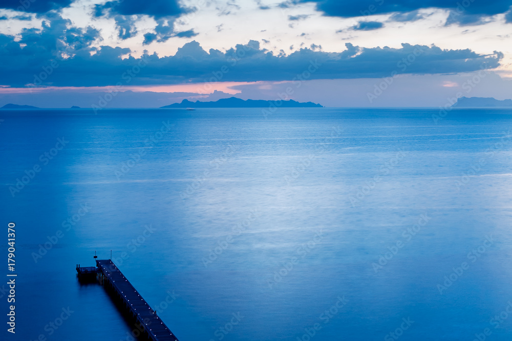 Top view of jetty or pier in blue color tone on evening time