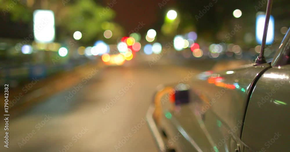 Slow motion shot of blurry street lights through a car at night in Nairobi. Kenya, Africa