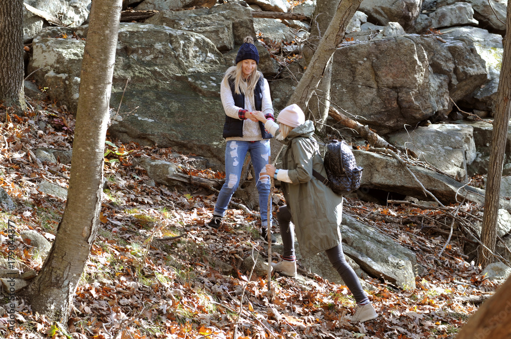 Girls walking in autumn forest in the mountains. Hiking and traveling