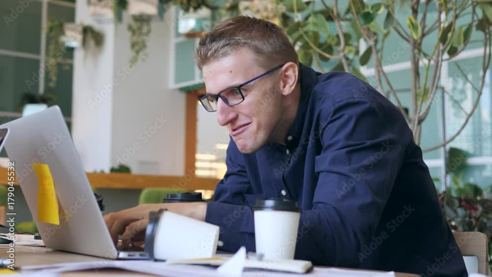 Funny Crazy Programmer with Caffeine Addiction Drinking Coffee and Typing Fast on Laptop in the Office. 4K.