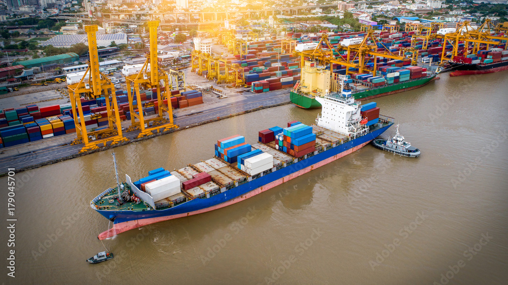 Obraz premium Logistics and transportation of Container Cargo ship and Cargo plane with working crane bridge in shipyard at twilight, logistic import export and transport industry background