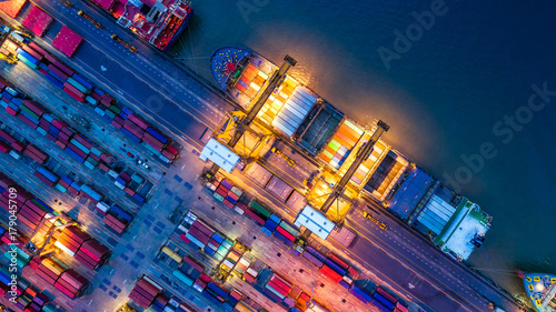 Container ship in import export and business logistics, By crane, Trade Port, Shipping cargo to harbor, Aerial view from drone, International transportation, Business logistics concept photo