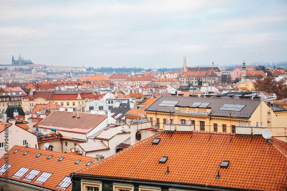 View from a high point. A beautiful view from above on the streets and roofs of houses in Prague. Traditional ancient urban architecture.
