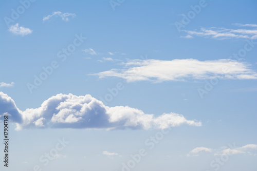 Puffy White Clouds Against a Pastel Blue Sky