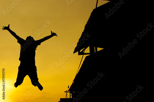 Silhouette Of Jumping Kids Against Sunset
