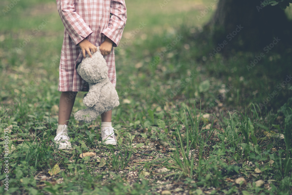 sad cute baby girl holding a bear toy, childhood
