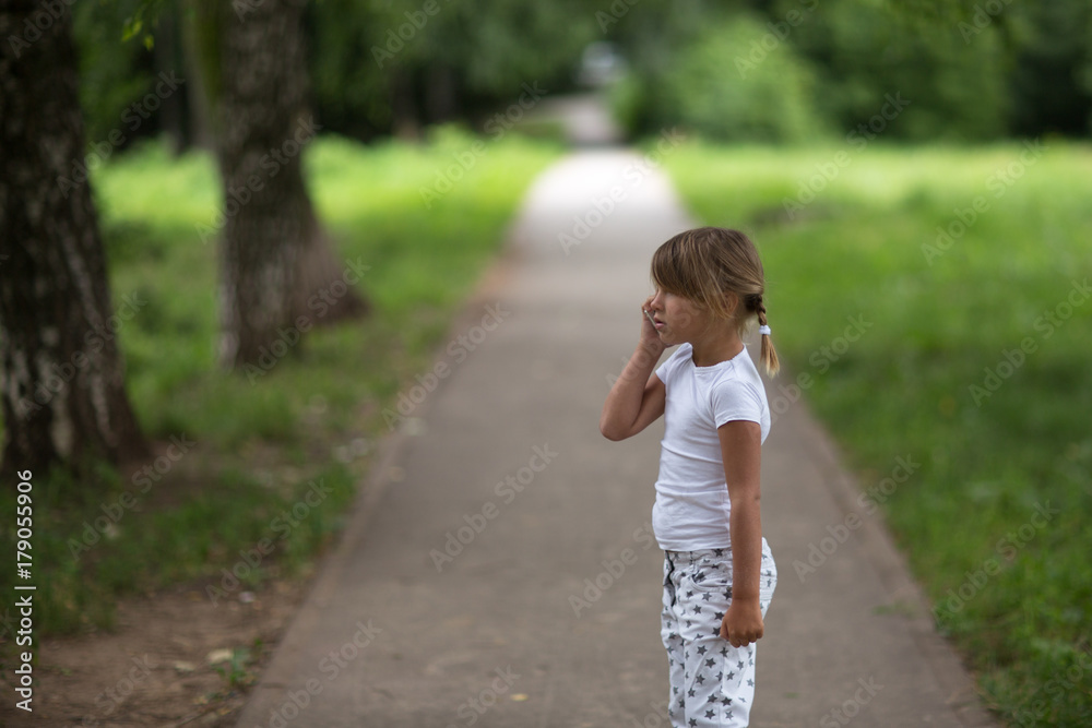 girl child talking on the phone strolling girl child talking on the phone strolling