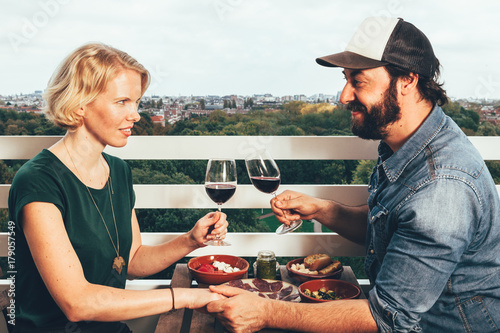 Canvas Print young couple dinner on a terrace above Amsterdam